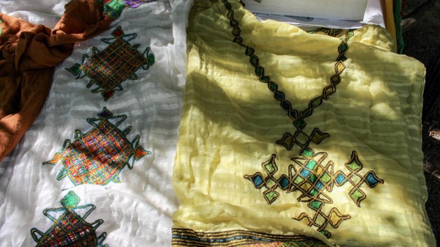 Traditional hand-knit Ethiopian clothing on a table for display. 