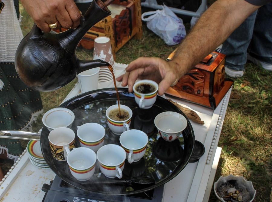 Coffee is an important part of Ethiopian culture. A coordinator pours buna, the term used for coffee, from a jebena, which is a clay coffee brewing pot, into cups for ceremony attendees.