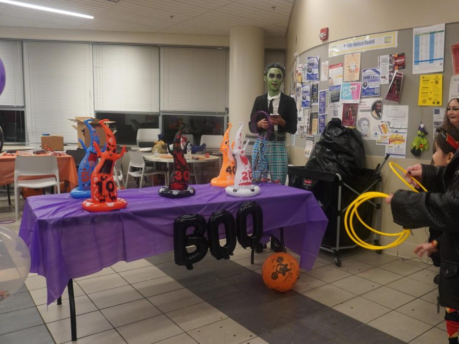 Students participate in a Halloween themed ring toss game.