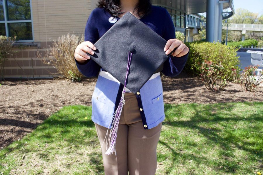Student holds blank graduation cap that will be decorated at the graduation cap decorating party. 