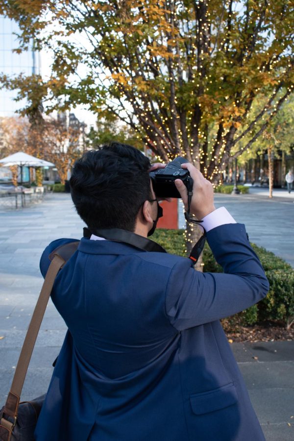 Diego Larin captures an image in downtown Washington D.C. while being captured himself.