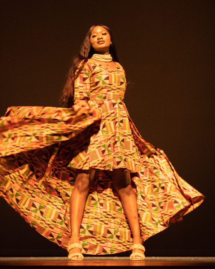 Susan Fomba from the ASA strutting the stage in the fashion show in a traditional dress.