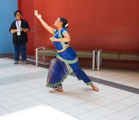 Spectators observe Sephira Amen at the Multicultural Fair on May 17. Amen, a general studies humanities major, dances a classical Indian dance style called Kuchipudi. Amen loves to dance. She said, “I started [dancing] when I was eight, [and] I love the family that I have created in my [dance] studio.”