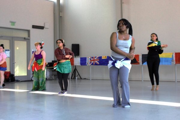 Dancers Julia Ostlund, Cassie Chew, Simret Aleligne, Henri Francisca No, and Fenet Shertaga practicing the dance move “row the boat” taught during the Caribbean Dance Workshop.