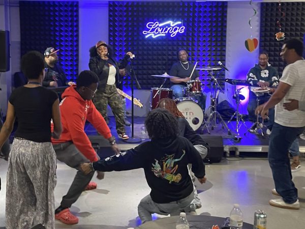 Students and staff dance together to live R&B music performed by The Kwick Experience during the Feb. 28 "Rhythm & Roots: Live R&B Experience" event in the CU Building.