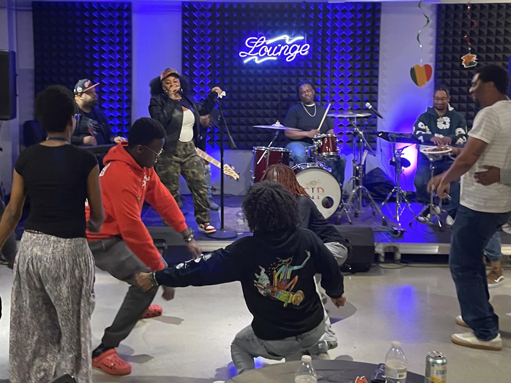 Students and staff dance together to live R&B music performed by The Kwick Experience during the Feb. 28 "Rhythm & Roots: Live R&B Experience" event in the CU Building.