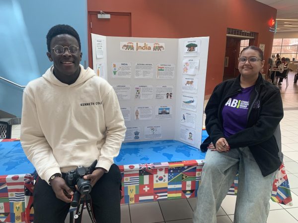 Cybersecurity major Karel "TK" Tabi, left, and communications major Jasjeet "Jas" Kaur Upal, right, sit by the India table during the March 26 Multicultural Fair on the first-floor ST Atrium.