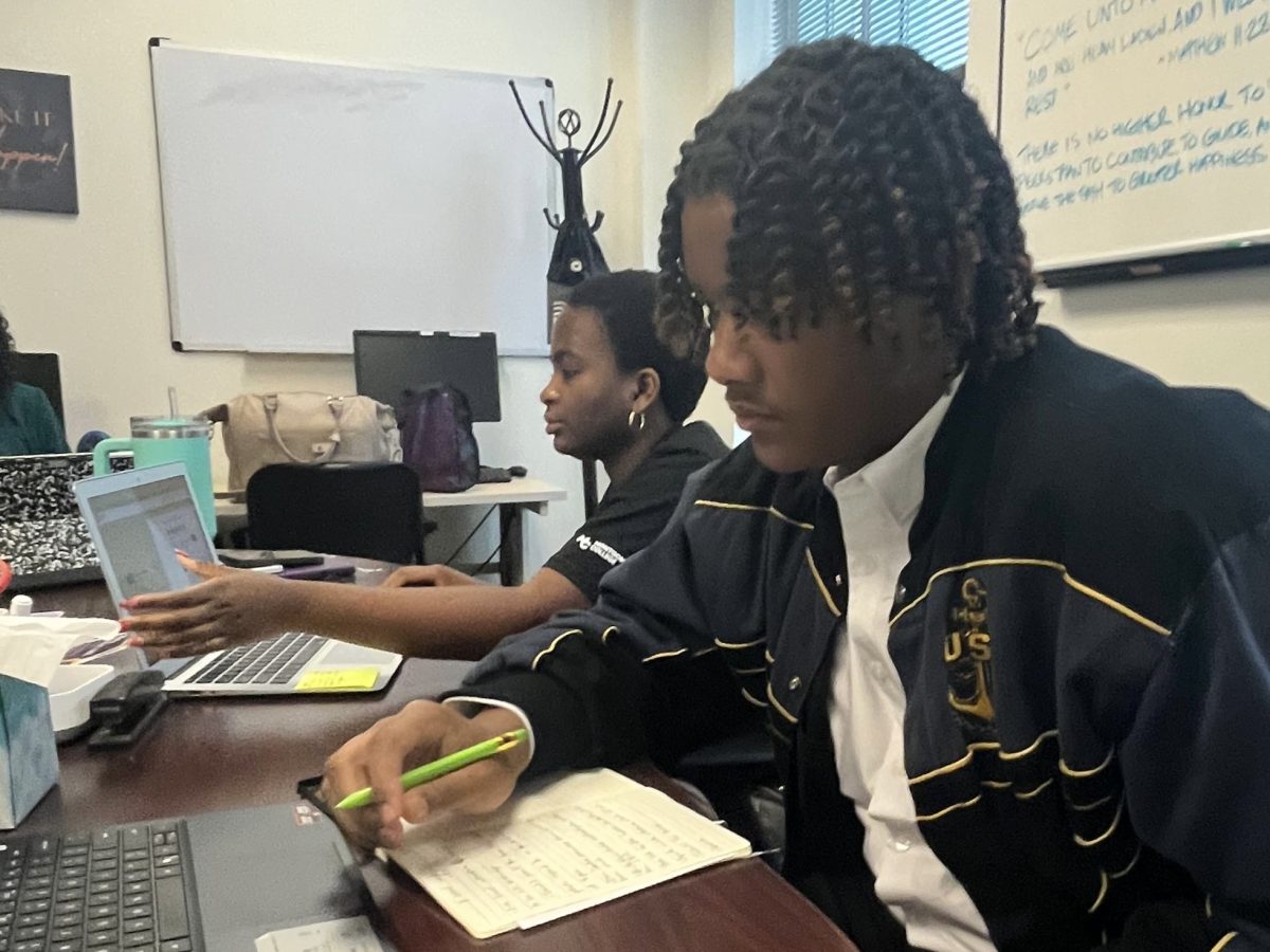Business administration major Marie-Therese Baderhakuguma, left, and electrical engineering major and Isaiah Smith, right, go over updates and plan the next agenda during an executive board meeting. Smith is the president of the Student Government Association (SGA) at the Takoma Park/Silver Spring campus.